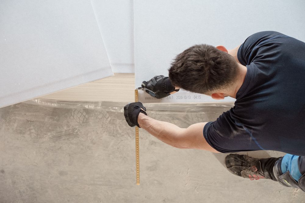 Worker measuring boards on a renovation site